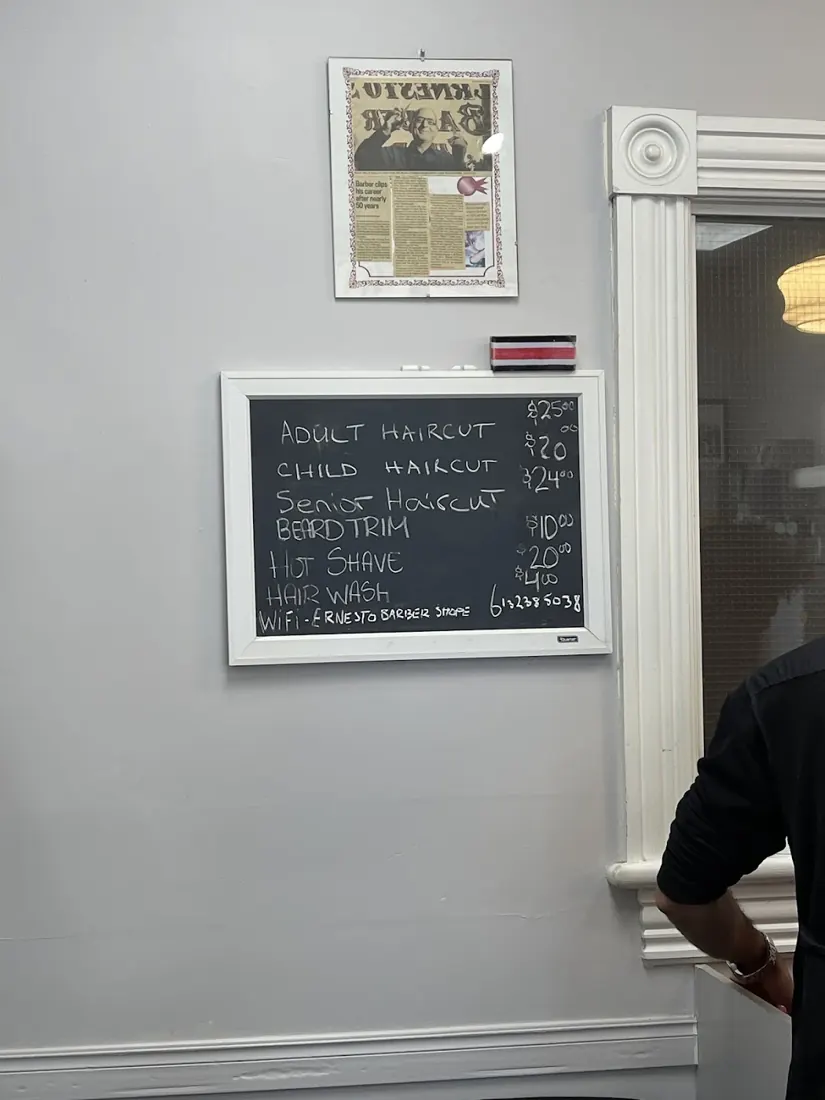 Chalkboard price and service list on the wall of Ernesto's
